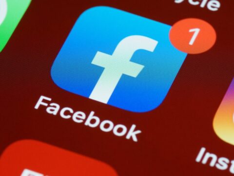 Closeup of phone screen showing Facebook and Instagram logos