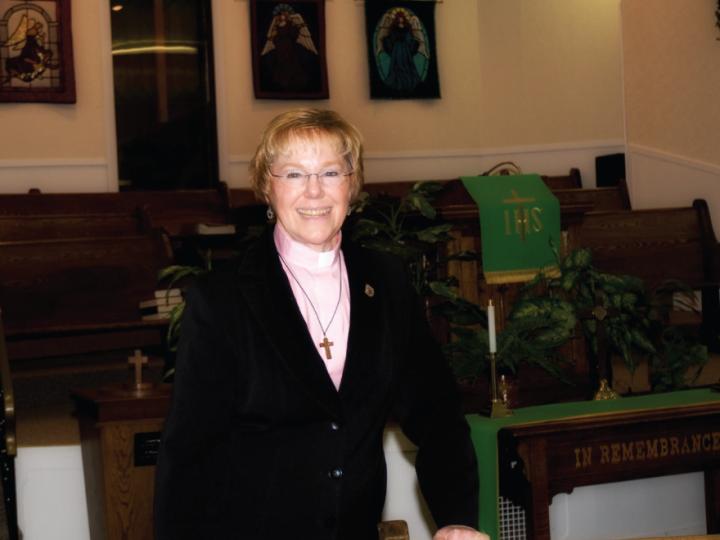 White female minister in church