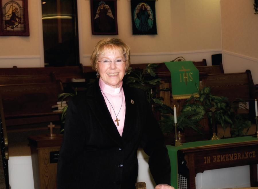 White female minister in church