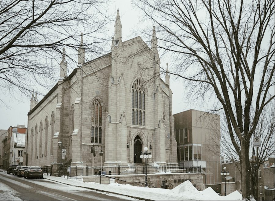 White church-like building with towering spires stands against a wintry landscape.