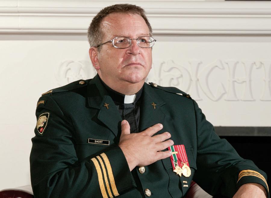 White male chaplain in military dress with hand on heart