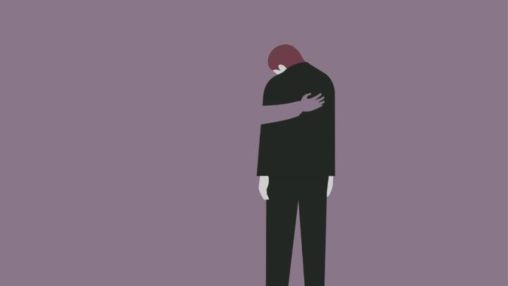 Illustration of a man in a black suit and black trousers. He has brownish hair and is looking down. The perspective is from behind. The background is purple and there is an arm on the man's back, comforting him.