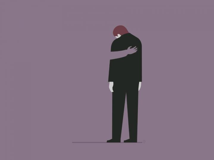 Illustration of a man in a black suit and black trousers. He has brownish hair and is looking down. The perspective is from behind. The background is purple and there is an arm on the man's back, comforting him.