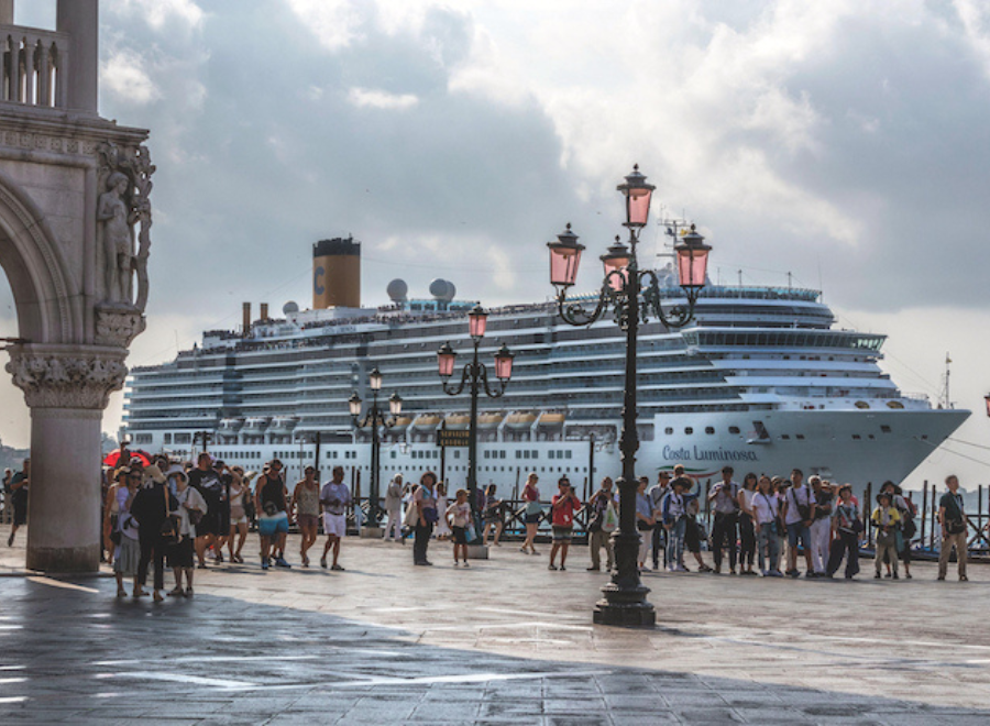 Crowds of tourists by a cruise ship in Venice