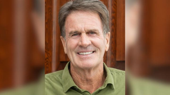 photo of smiling Caucasian man in a green collared shirt