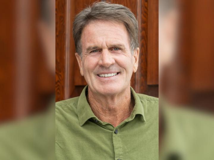 photo of smiling Caucasian man in a green collared shirt