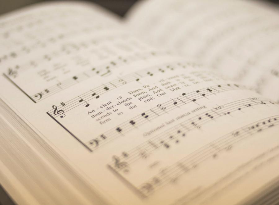 Close up of a hymn book showing musical notes and lyrics