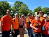 People pose for a photo wearing orange "Every Child Matters" shirts