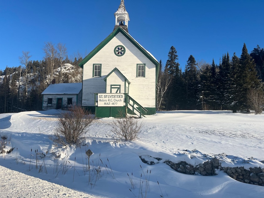 Image of a white church with a green roof and trim