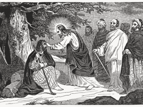 Woodblock illustration of Jesus healing a man sitting down holding a cane. Other men in robes stand behind Jesus and look on