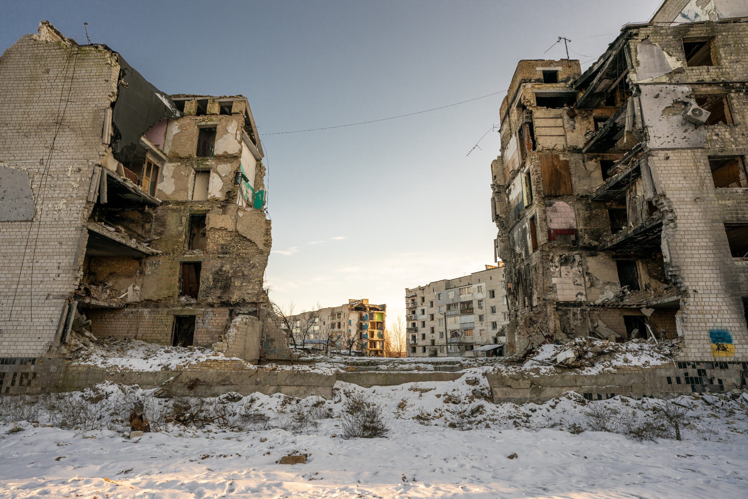 Landscape photo of multiple destroyed buildings and rubble