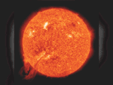 Image of a red ball, a solar filament exploding. It is a red and orange circle on a black background
