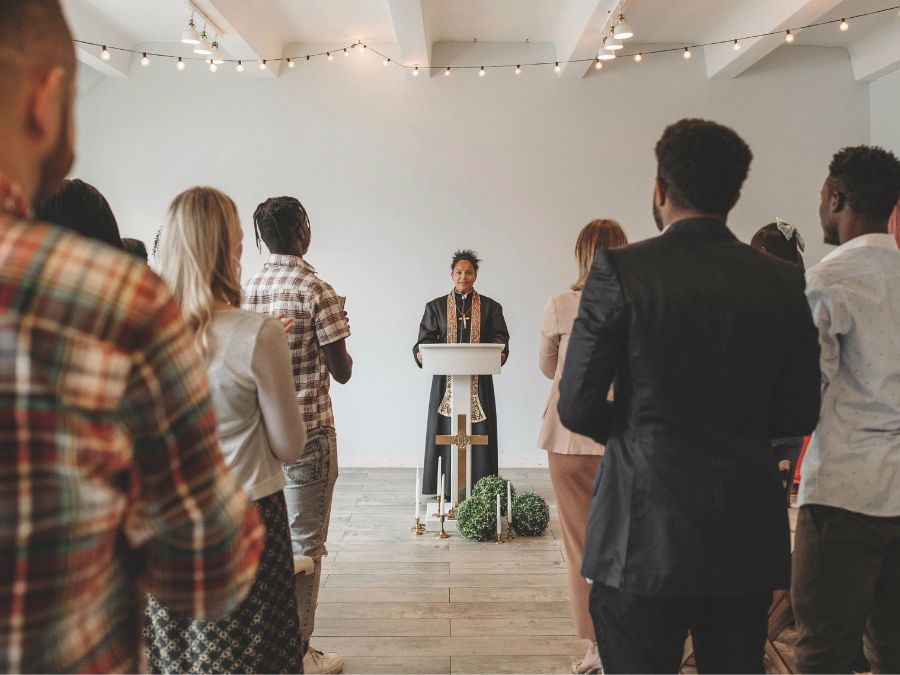 Minister stands at pulpit in front of congregation