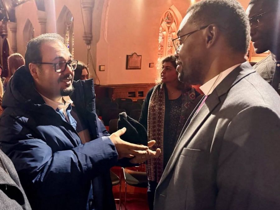 man in glasses talks to another man