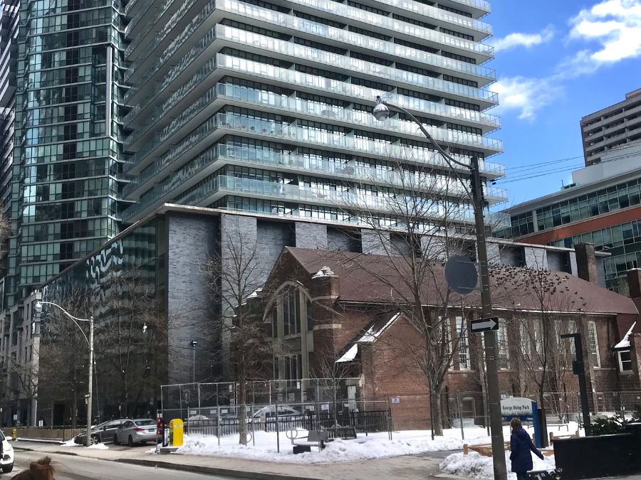 A church building is seen next to a new condominium