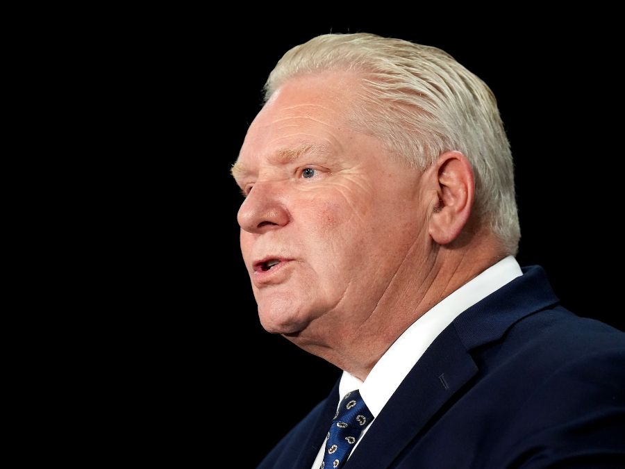 a Caucasian man in a suit is speaking